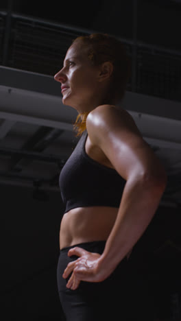 Vertical-Video-Shot-Of-Mature-Woman-Wearing-Gym-Fitness-Clothing-Sweating-Recovering-After-Exercise